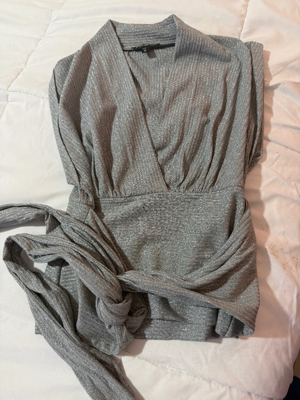 Express metallic V-neck blouse with a tie waist.